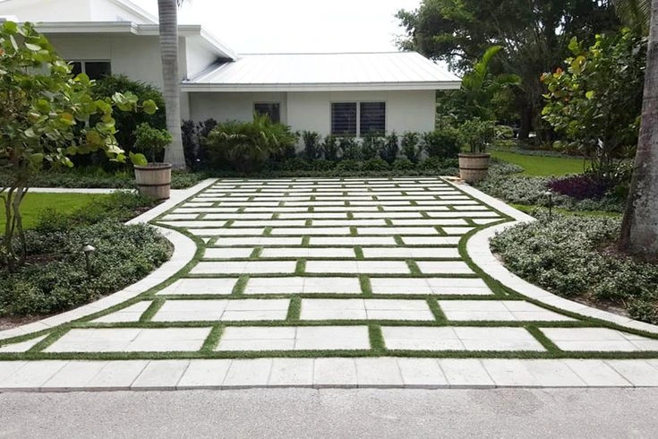 Desain halaman rumah dengan paving block dan rumput hijau yang tertata rapi